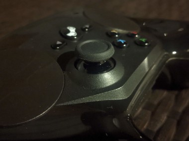 Steam Controller with a new replacement thumbstick, under unnecessarily dramatic lighting
