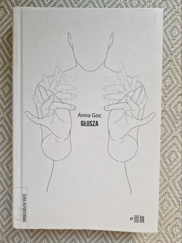 Książka "Głusza" Anny Goc. Biała okładka z migającą postacią