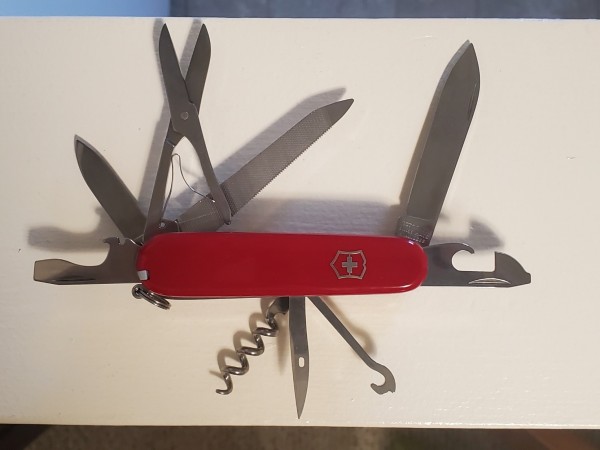 Victorinox Mountaineer multitool with main blade, small blade, scissors (best on a multitool, period), bottle opener/screwdriver/pry tool, can opener/flathead/Philips head, metal saw/metal file/ small Philips screwdriver, corkscrew, awl, hook, toothpick and tweezers