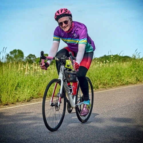 a photo of Steve Lawson on a bike smiling, wearing a Bike Project cycling jersey